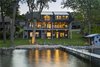 Modern home with Outdoor, Back Yard, Large Patio, Porch, Deck, Shrubs, Trees, Hanging Lighting, and Grass. Photo courtesy of Rehkamp Larson Architects provided by Marvin Windows and Doors Photo 7 of Lake Edge