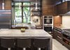 Modern home with Kitchen, Wood Cabinet, Pendant Lighting, Refrigerator, Wall Oven, Range, Range Hood, and Dishwasher. Builder John Kraemer & Sons’ Lake Calhoun Organic Modern residence, winner of 2016 Integrity Red Diamond Achiever Award Photo 4 of Lake Calhoun Organic Modern