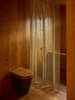 Modern home with Bath Room, Open Shower, One Piece Toilet, Medium Hardwood Floor, and Drop In Tub. Caroline Place is a minimalist home located in London, United Kingdom, designed by Groupwork + Amin Taha. Surrounded on three sides by eight and nine story mansion blocks shielding it from the heavy traffic on Bayswater Road and tourism on Queensway, Caroline Place is a quiet enclave of late 1950’s terraces north of Hyde Park and Kensington Gardens. Built with a Modern Northern European sensibility of sharp brick lines and crisp mortar joints layered with softer timber detailing, their interior layouts remained firmly rooted in an earlier English Edwardian tradition. Photo 4 of Caroline Place