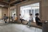 Modern home with Office. Located in Tokyo, Japan, the Mirror Window is a partial renovation of an office area within a building complex that is home to a workshop space, office, and contemporary art gallery. Kosaku Matsumoto completed the project following three months of an on-site residency to tackle a barren view of an adjacent house. A mirror was installed behind an existing window along the span of a concrete fence, while open-air space was created through reworking windows and exploring reflective effects of the mirror. Peering out the window, one can now take in not only a reflection of the interiors, but also adjacent walls and the neighborhood. Photo of The Mirror Window