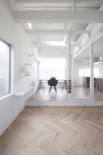 Living Room, Chair, Table, Light Hardwood Floor, and Shelves The living room is arranged on the second floor to create a sunny and comfortable environment.