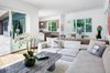 Modern home with Living Room, Chair, Sectional, Coffee Tables, Ceiling Lighting, and Medium Hardwood Floor. Living and dining space with indoor outdoor connection Photo 7 of Springs Residence