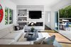 Modern home with Living Room, Sectional, Coffee Tables, Gas Burning Fireplace, and Medium Hardwood Floor. Living space opens completely to deck outside and rear yard Photo 8 of Springs Residence