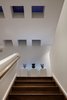 Modern home with Staircase, Wood Tread, and Wood Railing. hall and stair at night Photo 14 of Springs Residence