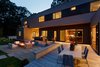 Modern home with Exterior, House, Prefab Building Type, and Wood Siding Material. rear yard and firepit at dusk Photo 16 of Springs Residence