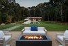 Modern home with Outdoor, Back Yard, Swimming Pools, Tubs, Shower, Trees, Walkways, and Stone Patio, Porch, Deck. Firepit and view to poolhouse Photo 17 of Springs Residence