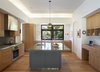 Modern home with Kitchen, Refrigerator, Range, Wood Cabinet, Concrete Counter, Range Hood, Pendant Lighting, Ceiling Lighting, Drop In Sink, and Light Hardwood Floor. Kitchen Photo 3 of Mt. Tam House