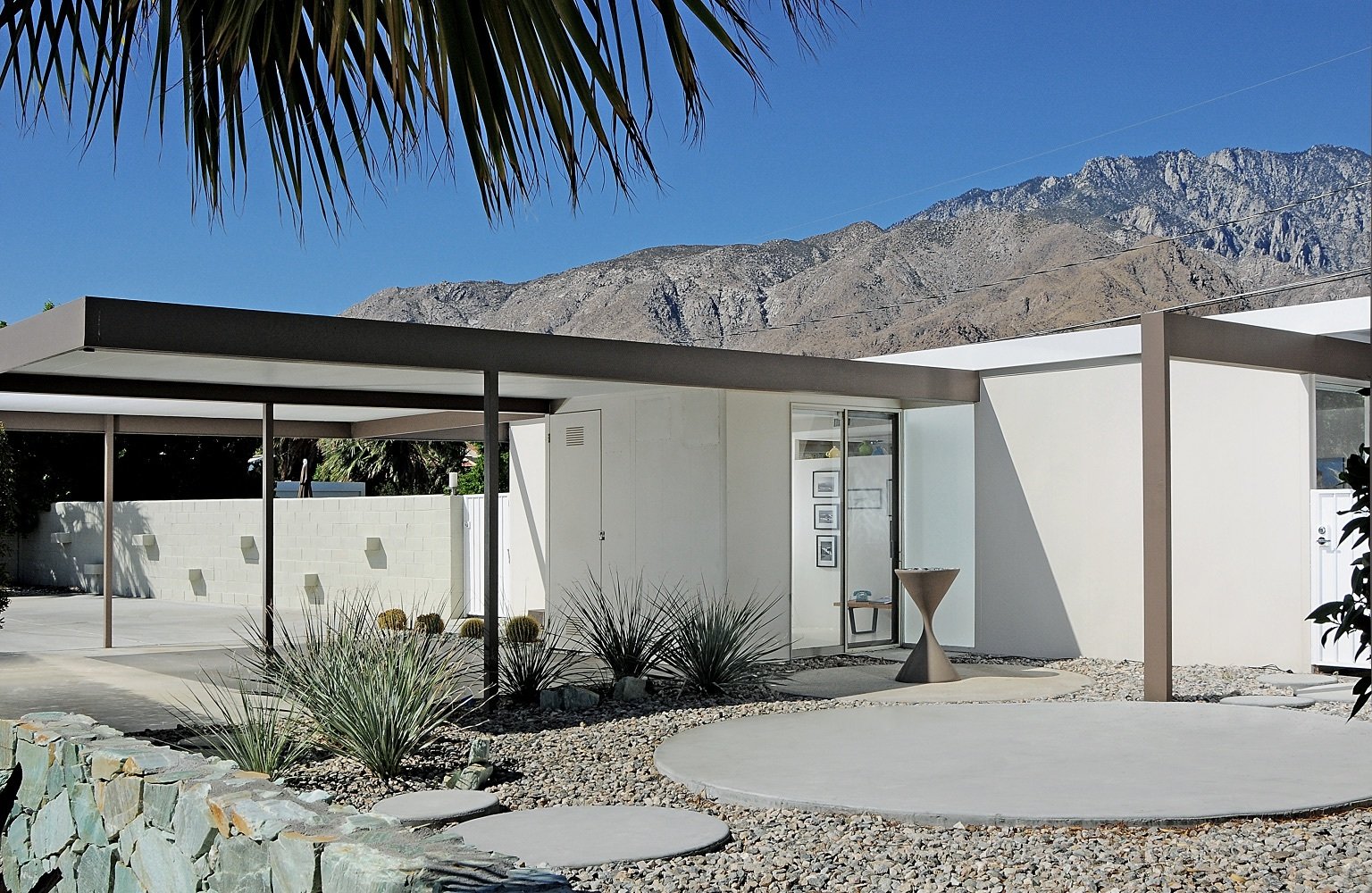The two-bedroom, two-bathroom house has a pool and an open air carport on a fourth-acre lot.