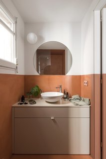 Bath Room, Vessel Sink, and Wall Lighting Cramped bathrooms can still benefit from greenery, too—even if it's just a couple of leaves.