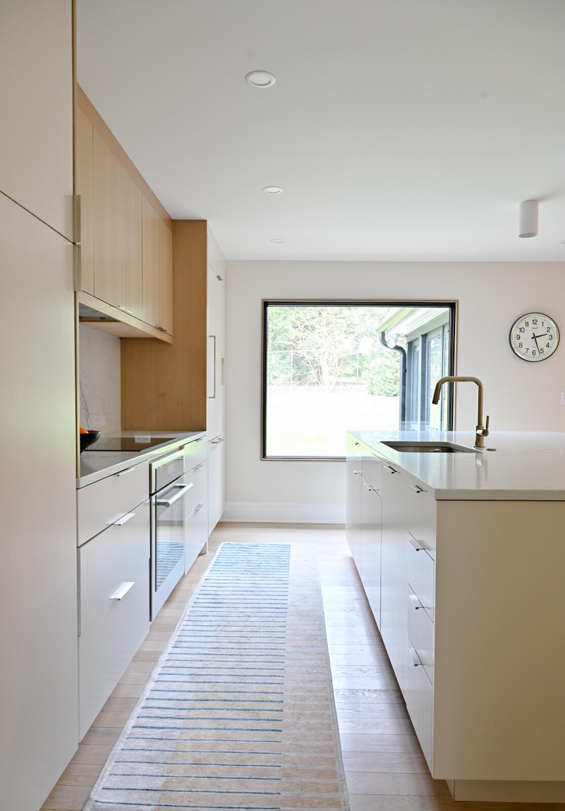 A large picture window opens the kitchen up to the outdoors.