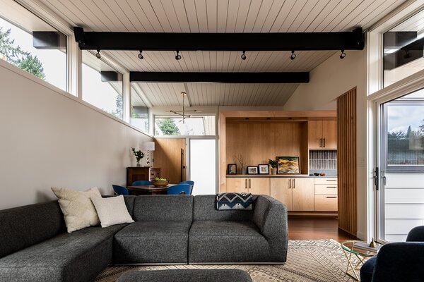 The living room features a Malibu sofa from Kasala, and it sits above a Moroccan wool carpet the owner inherited.