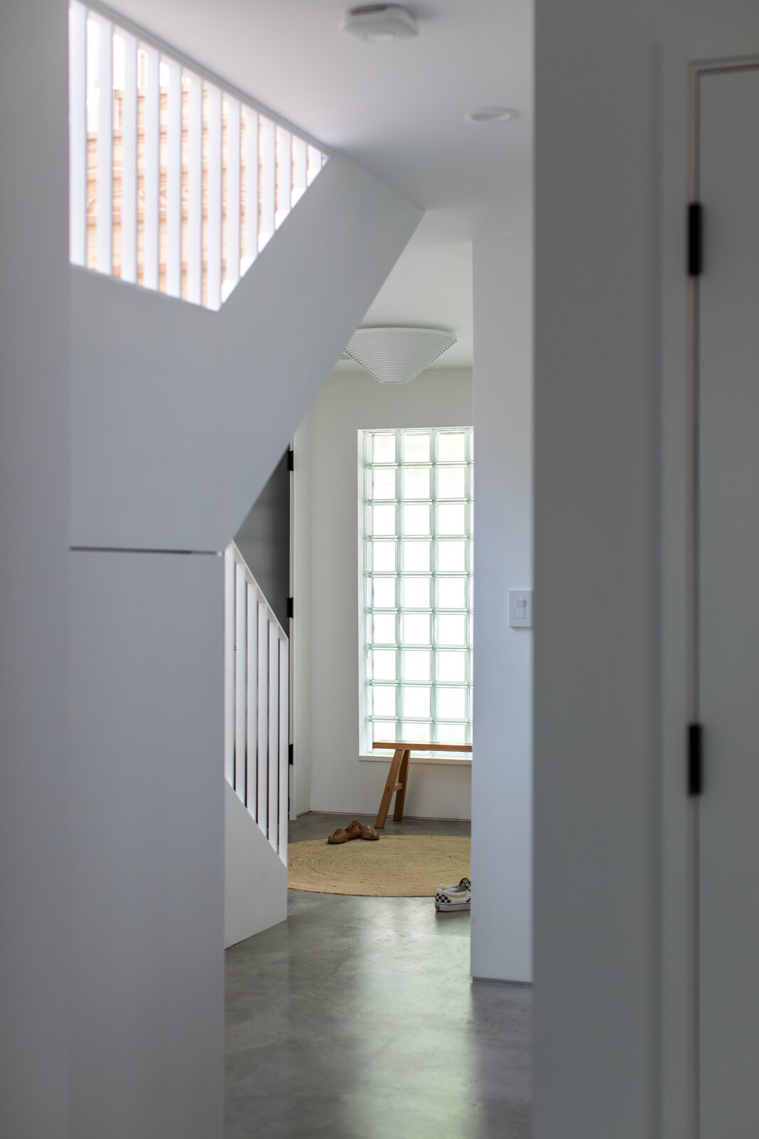 The couple chose to install glass blocks to allow natural light in while still providing privacy. They treated the home's concrete slab to act as the flooring.
