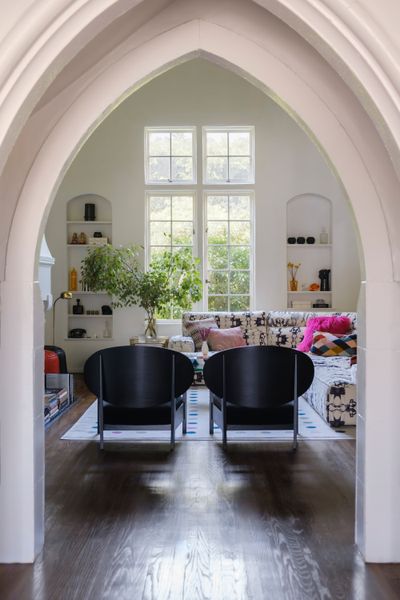 The living room features original hardwood floors and moldings—plus an 18-foot ceiling.