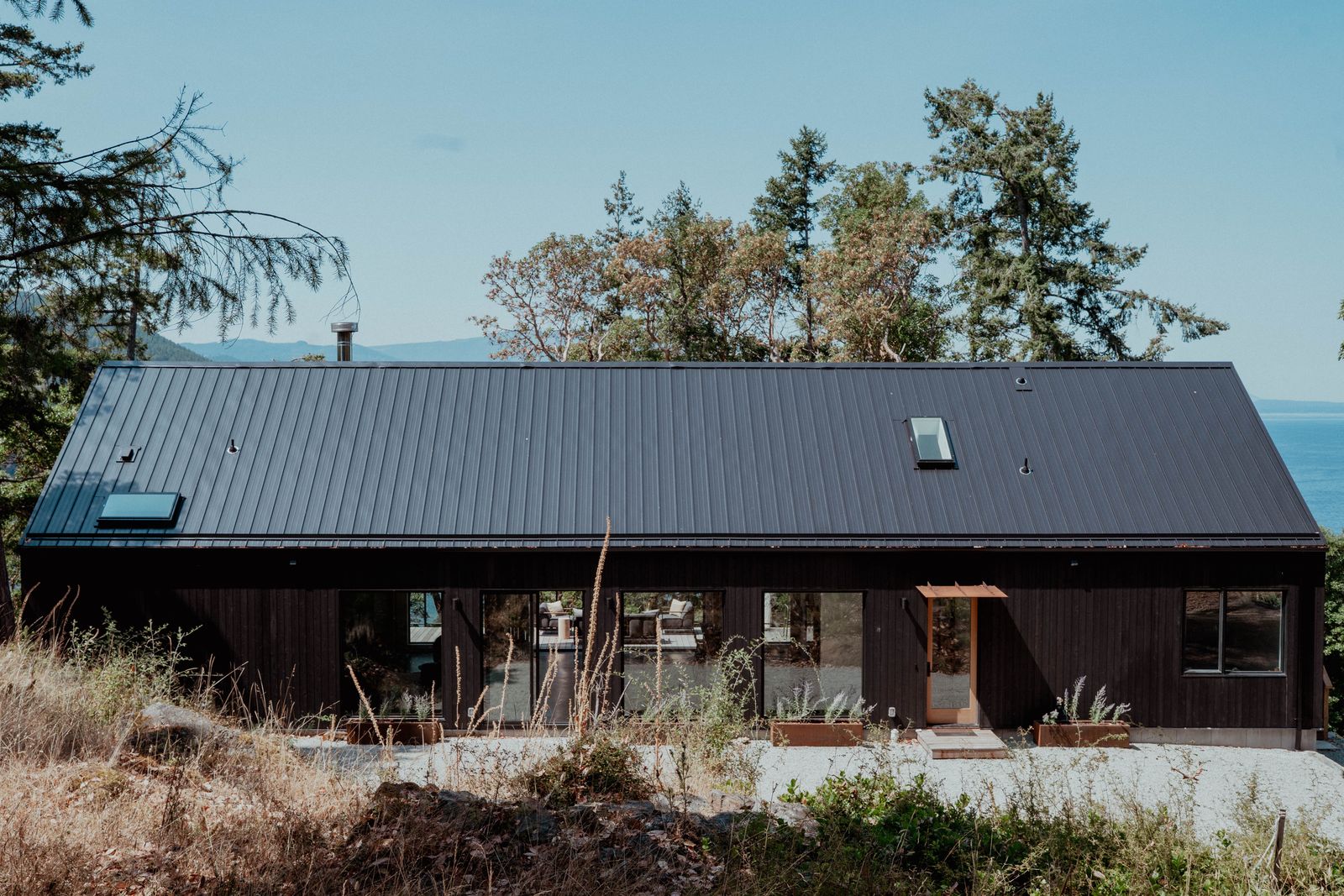 The natural aged cedar exterior is protected by a steel roof.