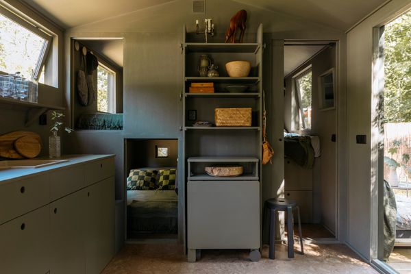 The built-in storage at the center of the room has a desk that folds out when needed. The three cubbies lead to bedrooms that can sleep a total of six.