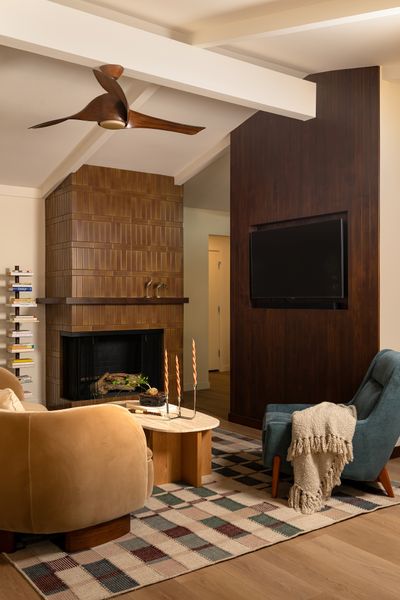 The renovation removed a wall between the living room and kitchen, and created more room with an addition. The remodeled fireplace cost $2,600.
