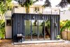 Modern home with Exterior, House Building Type, Flat RoofLine, and Metal Siding Material. Exterior view - doors closed Photo 2 of Ballard Residence