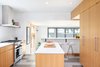 Modern home with Kitchen, Recessed Lighting, Engineered Quartz Counter, Range, Ceramic Tile Backsplashe, Undermount Sink, Wood Cabinet, Range Hood, and Linoleum Floor. Kitchen Photo 3 of Ballard Residence