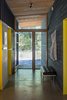 The hall, bookended by glass on either side and with its roofline extending beyond, lightens the visual impact of the house by ceding prominence to views of the site. Photo 6 of Lot 6 modern home