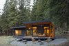 At night, the quiet drama of the shed roof's angles glows against the darkened forest. Photo 8 of Lot 6 modern home