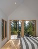 Modern home with Bedroom, Bed, Light Hardwood Floor, Chair, and Recessed Lighting. In the master bedroom, Douglas firs filter the light and mountain views for a more intimate experience. Photo 6 of The Coyle
