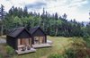 Modern home with Exterior, House, Cabin Building Type, Gable RoofLine, and Wood Siding Material. The main living spaces were divided into two distinct volumes, slightly offset to maximize the stunning -- and remarkably different -- views from the property. A common entry rejoins the two structures. Photo 8 of The Coyle