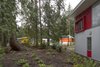 Modern home with Outdoor, Trees, Landscape Lighting, Flowers, Back Yard, Woodland, Grass, Gardens, Wood Patio, Porch, Deck, Decking Patio, Porch, Deck, Shrubs, Field, Hardscapes, Side Yard, Small Patio, Porch, Deck, and Garden. A carefully-chosen color palette, composed of warm reds, oranges, and yellows, contrasts to the cool tones of the forest. Photo 8 of Whidbey Artists' Retreat