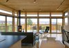 Modern home with Dining Room, Corner Fireplace, Track Lighting, Chair, Wood Burning Fireplace, Light Hardwood Floor, Table, Ceiling Lighting, and Bar. The climb up the stairs culminates in a breathtaking, glass-wrapped kitchen/living/dining space at the fourth level. Photo 7 of Tower House