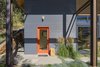 Modern home with Doors, Wood, Exterior, and Swing Door Type. Bright orange paint trims glass doors set in the corrugated metal siding, providing a cheerful contrast. Photo 3 of Chechaquo