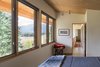 Modern home with Bedroom, Concrete Floor, Bed, Chair, and Ceiling Lighting. In the summer, the deep roof overhangs shade the two upstairs bedrooms, while also letting in enough sunlight to penetrate the interior in the winter. Photo 8 of Chechaquo