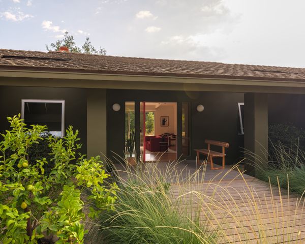 With no major structural work to do, the design team focused on things like color, and on the exterior they paired Benjamin Moore’s Cabbage Patch green with a front door painted in the company’s Tawny Day Lily.