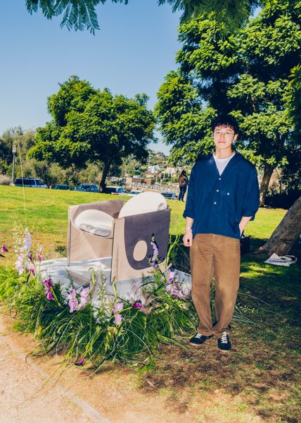 Designer Oscar Chang stands beside his Vesta chair.