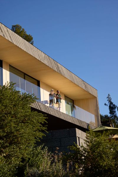 Shou sugi ban siding by Delta Woodworks set on the diagonal clads the second floor.