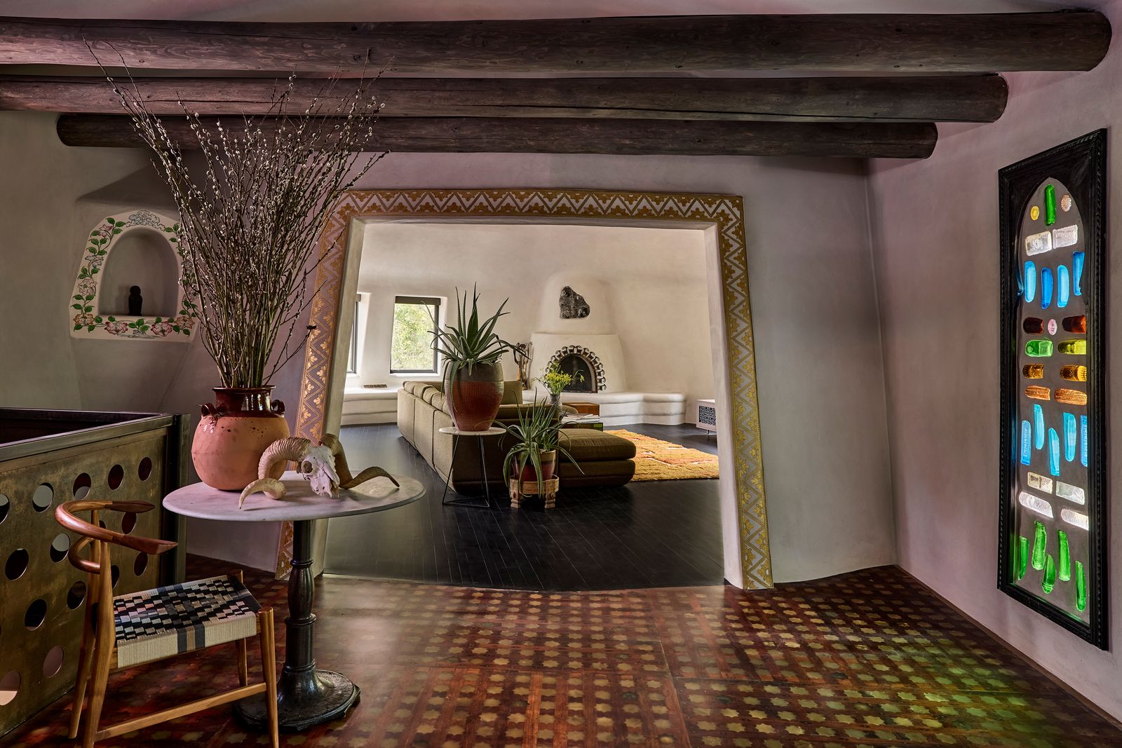 The existing openings to the living room (above) and the kitchen-dining room were enlarged. Justin asked Santa Fe-based Tibetan master painter Lama Gyurme, the artist who did the decoration originally, to reproduce the design.