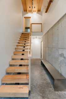 The interior stair is composed of floating treads sourced from trees cut down on the  property. A mix of oak, maple, and birch, each step is different and unique.