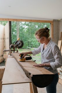 The home’s multifunctional layout gives Marica dedicated space for woodworking in her workshop, and Brock for tinkering with antique cars in the garage.