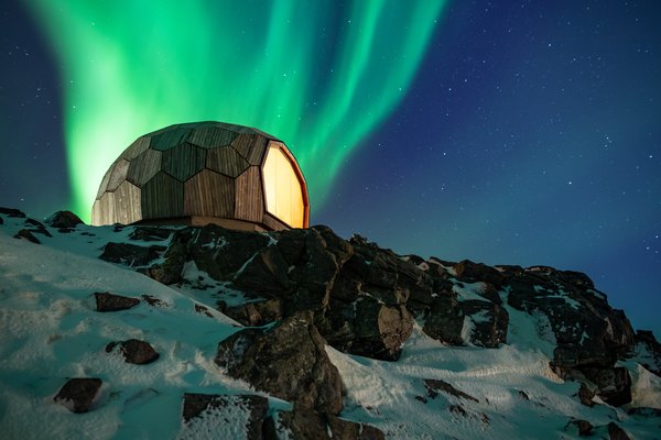 The Hammerfest Cabin is perched high atop a rocky slope.