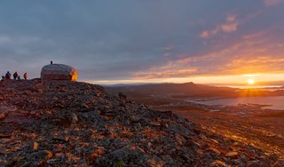 The cabin's faceted, geometric shell is specifically designed to withstand harsh weather conditions. The structure underwent rigorous wind and snow simulations before any construction on the mountain began.