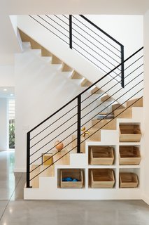 Clever cubby storage is incorporated into the base of the interior stairs, while the extra-deep stair treads provide flexible "stadium-style" seating for the kids.