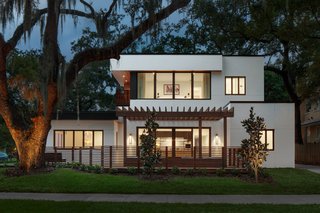 The home's dramatic eastern elevation asserts a more commanding presence with expansive glazing on both levels, boldly "opening up" to visitors and passersby.