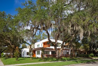 A "grand oak," one of seven mature oak trees dotted around the property, towers majestically  over the home. This tree, vehemently protected by the city, would play a prominent role in site planning.