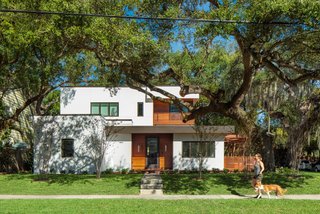 Situated on a corner lot with two "front yards," the home is uniquely positioned to make distinctive statements from each street-facing vantage point. The home's southern entry features modest glazing and warm, cedar accents.