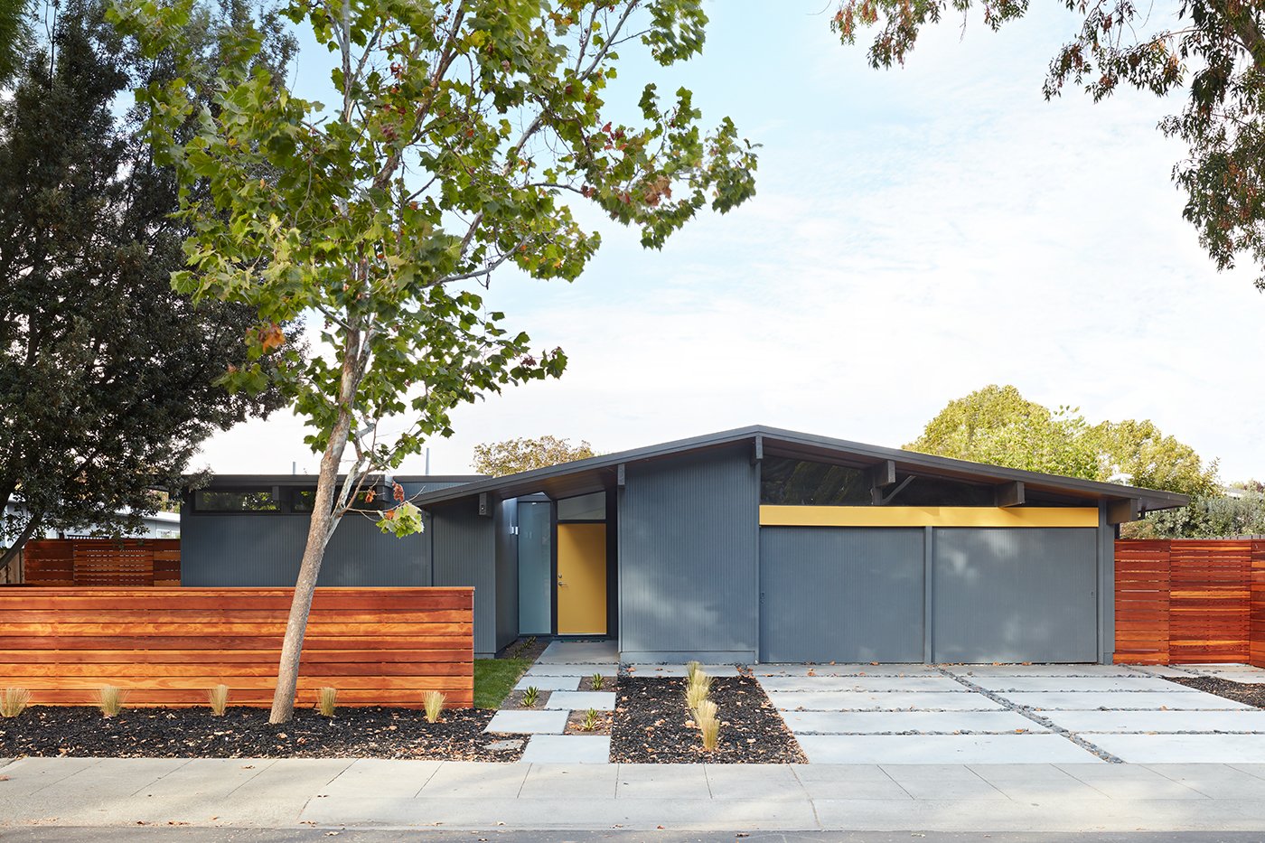 Klopf Architecture's modest 72-square-foot addition at the front of the home blends in with the original structure while giving the owners a greater sense of openness in the master and hall bathrooms. Inside, the re-imagined great room now features dining space.