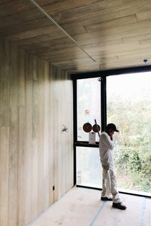The den, Brunn says, is like a wood-clad "tube," drawing the eye out to the view beyond. Casement and fixed windows from the Series 670 line, along with a Series 600 Window Wall, help celebrate the tranquil wooded landscape.