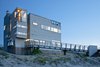 Modern home with Exterior, House Building Type, and Wood Siding Material. Northeast corner at entrance Photo 3 of Dune Road Beach House