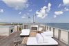 Modern home with Rooftop, Wood Patio, Porch, Deck, Horizontal Fences, Wall, Wood Fences, Wall, and Exterior. Roof deck/Outdoor living space Photo 17 of Dune Road Beach House