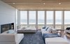 Modern home with Medium Hardwood Floor, Wood Burning Fireplace, Ceiling Lighting, Sofa, and Living Room. Living room and view of Atlantic Ocean upon entry Photo 10 of Dune Road Beach House
