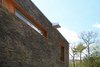 Stacked stone wall, cedar window trim, and custom overflow scupper Photo 6 of Catskills Suburban modern home