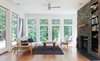 Modern home with Living Room, Rug Floor, Medium Hardwood Floor, Sofa, Shelves, Chair, Standard Layout Fireplace, Recessed Lighting, Coffee Tables, and End Tables. Natural ledgestone surrounds the fireplace in the living space Photo 12 of Catskills Suburban