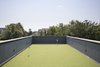 Modern home with Exterior, Green Roof Material, Flat RoofLine, House Building Type, and Wood Siding Material. Putting green on the roof deck Photo 7 of North Fork Bluff House